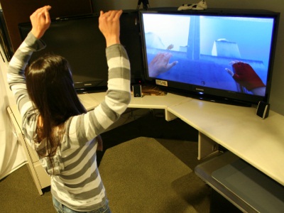 A player performs a jump/high gesture to climb onto a platform.